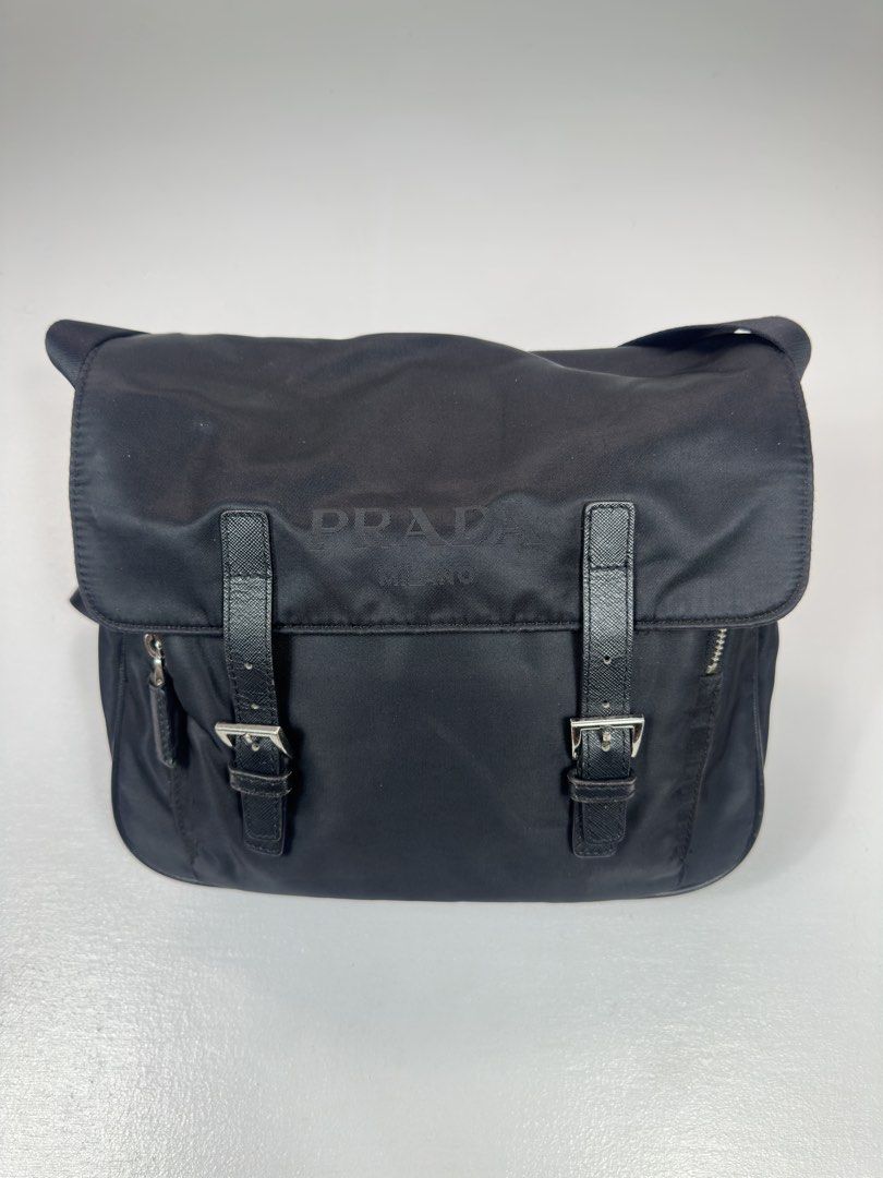 Prada Black Nylon Messenger Bag (Category: Luxury Bags & Wallets) located in Manila. Submitted by collect__ph (Listing ID 1444905963, Image 3). Description: - Black nylon with leather accents - Adjustable shoulder strap with Prada branding - Multiple zip compartments for storage - Silver hardware details - Ideal for everyday use.