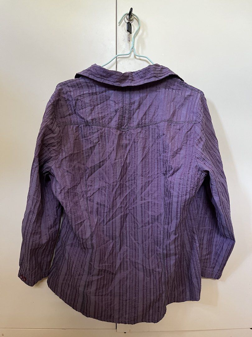 purple punk button down (Category: Shirts) located in Nabua. Submitted by twelvet (Listing ID 1444882458, Image 2). Description: - Unique purple collared shirt - Textured stripe pattern - Cool graphic print on front left - Button-up style with single collar button - Size: Medium (M) - Versatile: Dress up or down.