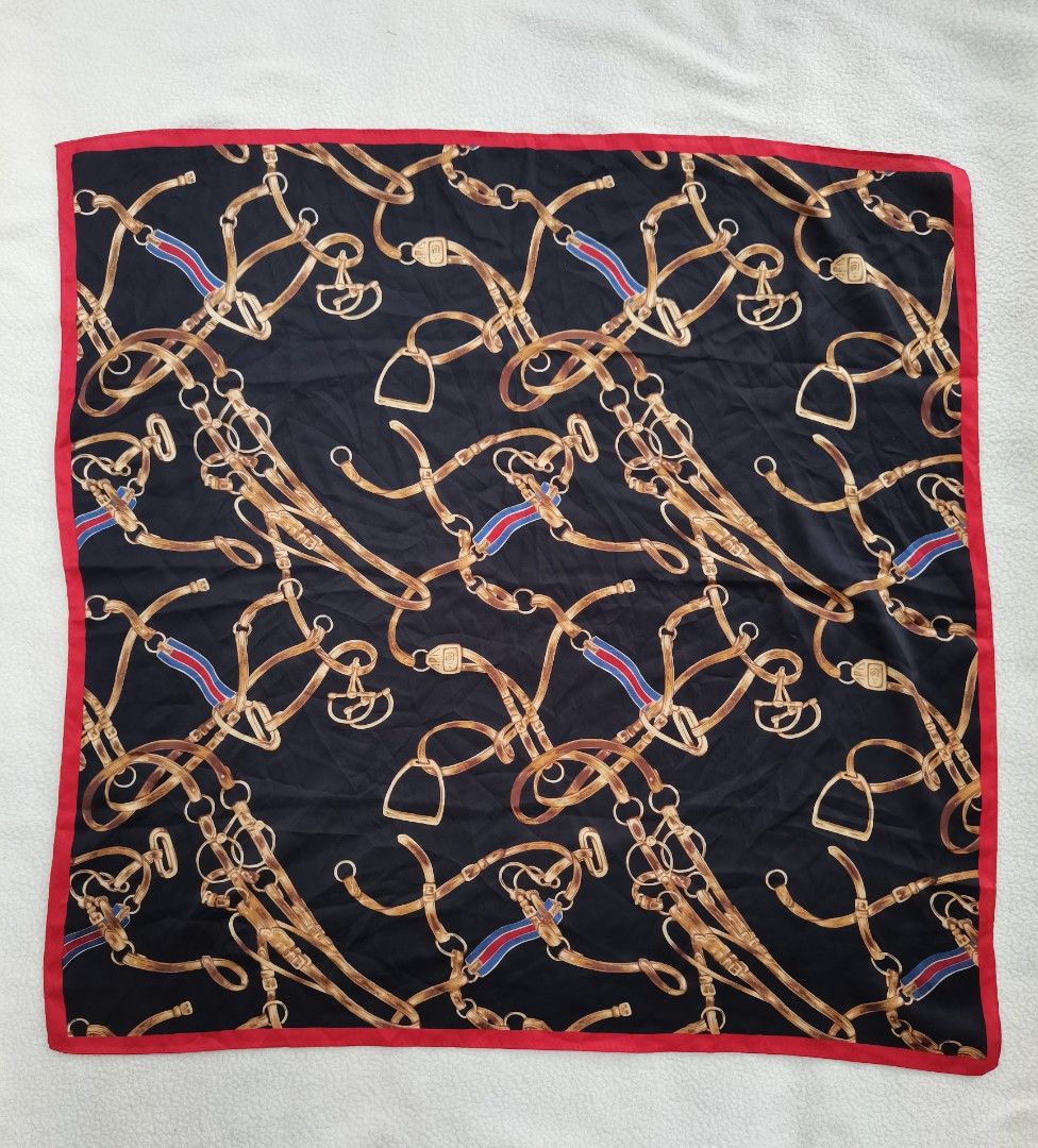 vintage equestrian belt and chain pattern SCARF (Category: Scarves) located in Santa Cruz. Submitted by oddpenguin-4575 (Listing ID 1444988311, Image 2). Description: 📌.....P L E A S E R E A D..... 📌measurement:L-28"/W-27" 📌color-10/10 📌Brand:no brand 📌issue:❌ 📌-black square scarf features a vintage equestrian belt and chain pattern with a contrasting red border. 📌Actual shades may differ slightly depending on ambient lighting conditions. 