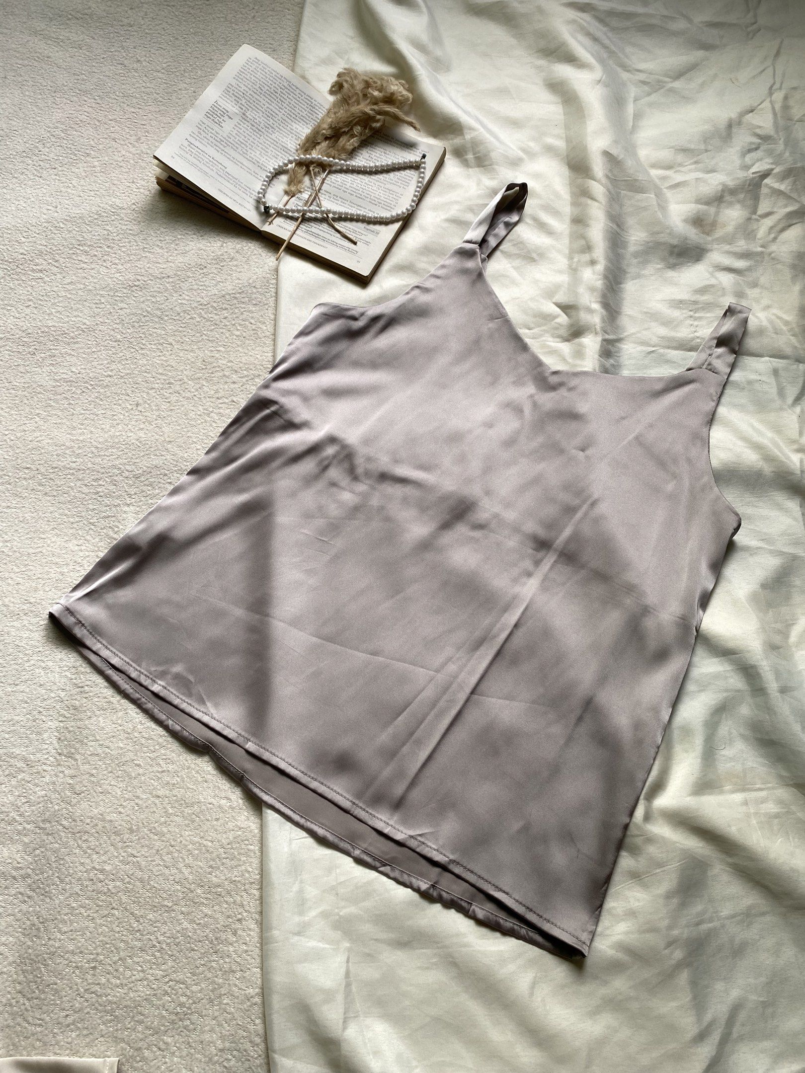 Satin Camisole Top - Grey Small Bust 34 (Category: Sleeveless) located in Poro. Submitted by joyceyuu (Listing ID 1445006858, Image 3). Description: - Lightweight satin camisole - Simple V-neck design - Adjustable straps for a perfect fit - Soft and smooth fabric for ultimate comfort - Versatile: great for layering or wearing on its own - Pairs well with jeans or skirts.