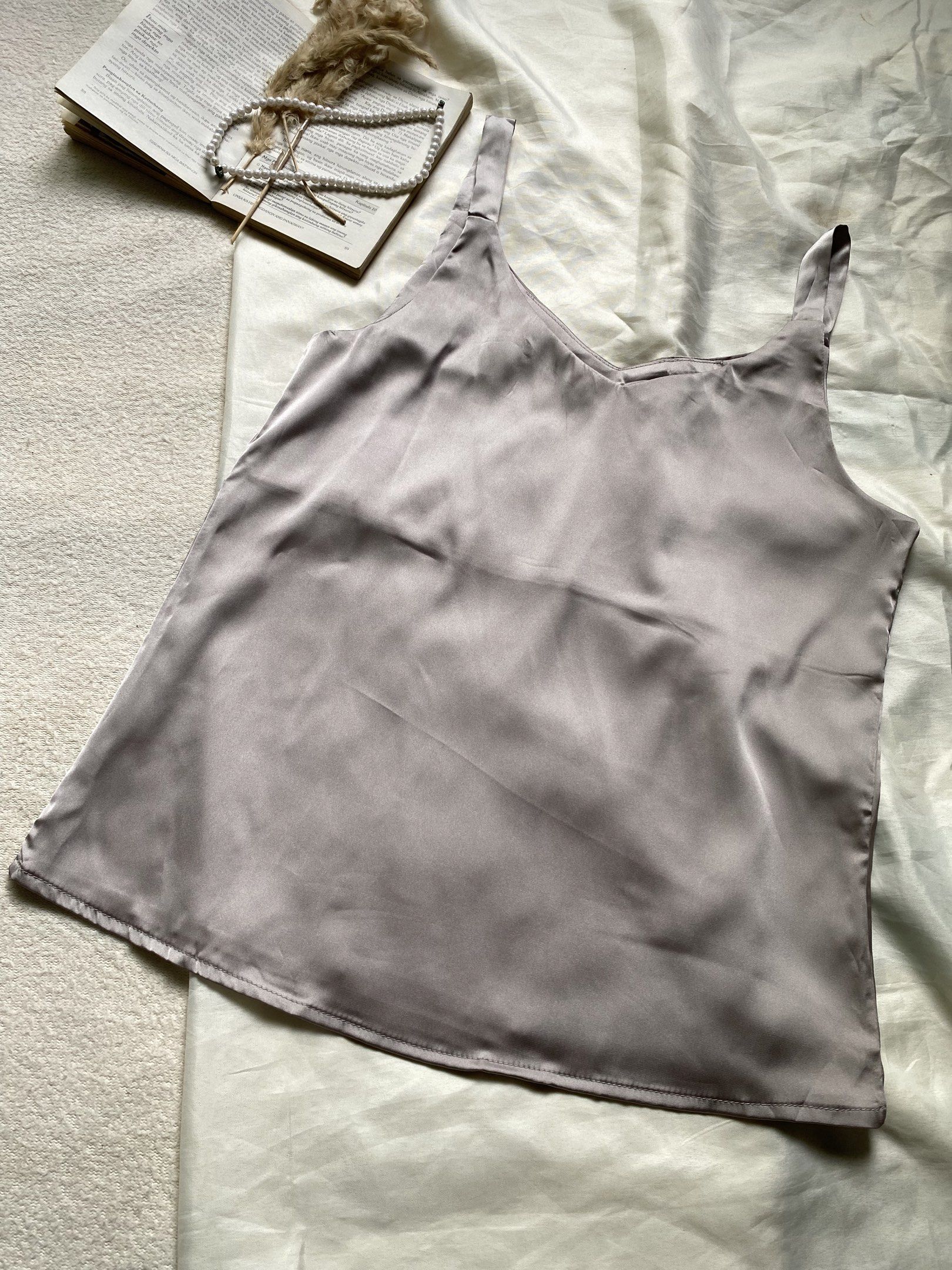 Satin Camisole Top - Grey Small Bust 34 (Category: Sleeveless) located in Poro. Submitted by joyceyuu (Listing ID 1445006858, Image 2). Description: - Lightweight satin camisole - Simple V-neck design - Adjustable straps for a perfect fit - Soft and smooth fabric for ultimate comfort - Versatile: great for layering or wearing on its own - Pairs well with jeans or skirts.