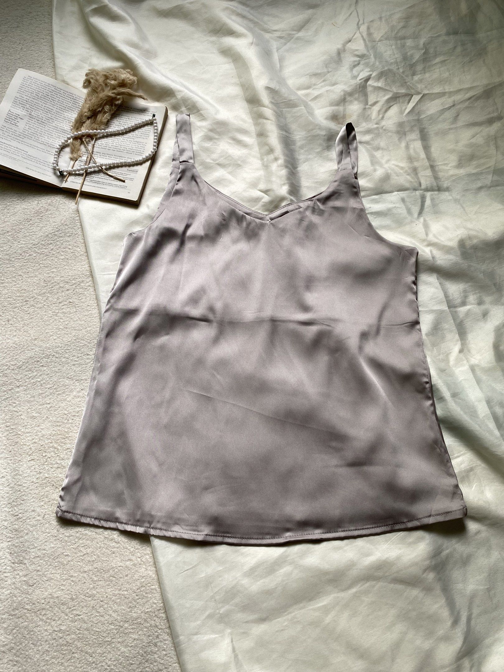 Satin Camisole Top - Grey Small Bust 34 (Category: Sleeveless) located in Poro. Submitted by joyceyuu (Listing ID 1445006858, Image 1). Description: - Lightweight satin camisole - Simple V-neck design - Adjustable straps for a perfect fit - Soft and smooth fabric for ultimate comfort - Versatile: great for layering or wearing on its own - Pairs well with jeans or skirts.