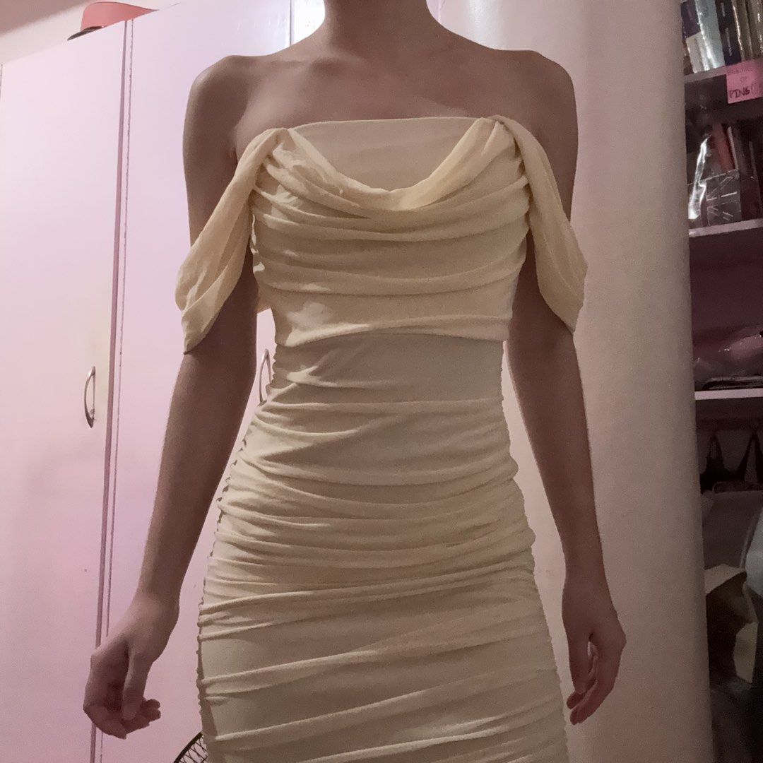 SHEIN Off-Shoulder Ruched Draped Mesh Dress (Category: Dresses) located in Taguig. Submitted by xoalexv (Listing ID 1444903367, Image 2). Description: - Cream/light yellow off-shoulder dress - Draped mesh overlay with ruched detailing - Bodycon fit - Features small rings on the sleeves - Ideal for a night out or special occasion - wore this as my graduation dress.