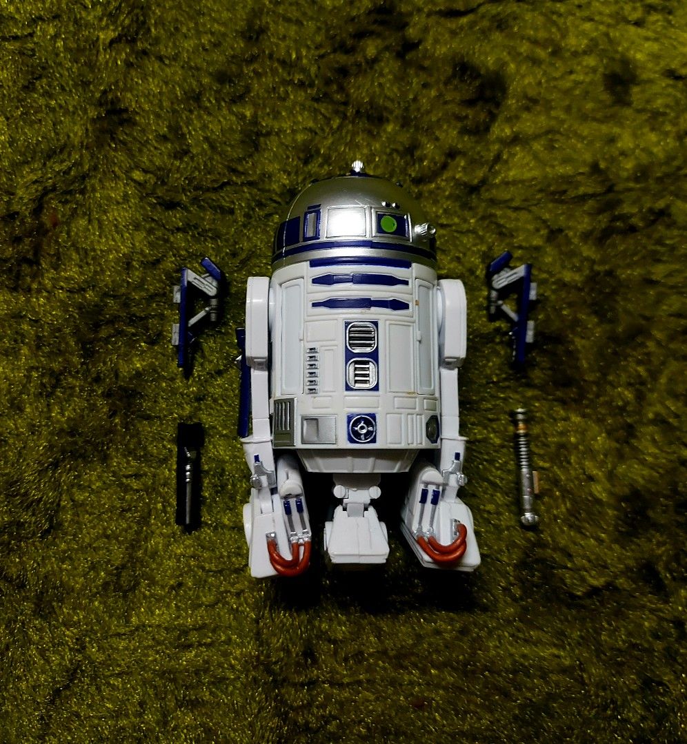 Star Wars R2-D2 Action Figure with Accessories (Category: Figurines & Statues) located in Caloocan City. Submitted by hobbym8 (Listing ID 1444871362, Image 1). Description: - Authentic Star Wars R2-D2 action figure - Features iconic white, blue, and silver droid design - Includes a lightsaber accessory - Comes with other detachable parts for customization - Accessories are black and silver - A must-have for any Star Wars fan's collection.