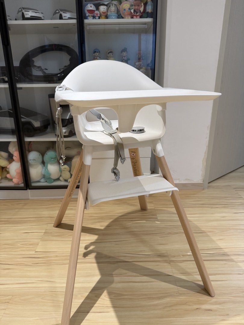 Stokke Clikk Baby High Chair (Category: Baby High Chairs) located in Singapore. Submitted by dinosour0101 (Listing ID 1444996649, Image 2). Description: - White high chair suitable for babies and toddlers - Features a secure safety harness - Stylish modern design with wooden legs - Easy to wipe clean for hassle-free maintenance - Ideal for making meal times enjoyable and safe.