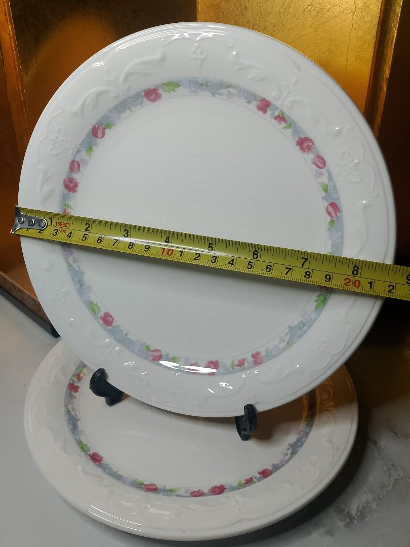 Super China Dinner Plates Set of 2 Floral Pattern (Category: Dinnerware & Cutlery) located in Valenzuela. Submitted by buylaaaaa (Listing ID 1444934773, Image 3). Description: - Set of 2 Super China dinner plates - Diameter: Approximately 8.5 inches - Color: White with delicate pink and blue floral border - Features embossed detailing on the rim - Note: Some visible crazing on the surface - Ideal for everyday dining or decorative display.