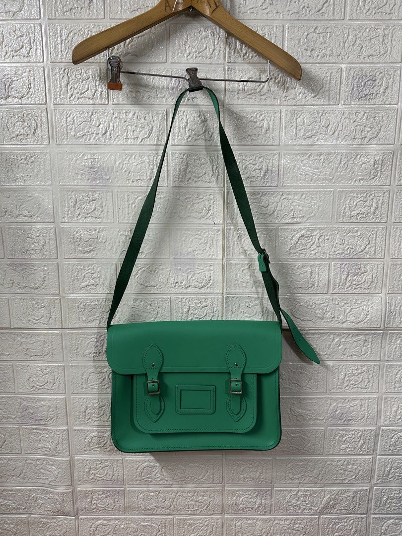The Cambridge Satchel Company Green Leather Satchel Bag (Category: Luxury Bags & Wallets) located in Bacoor. Submitted by reneejhay (Listing ID 1444983361, Image 1). Description: - Genuine green leather satchel bag - Brand: The Cambridge Satchel Company - Classic design with secure buckle closures - Adjustable shoulder strap for comfort - Ample interior space for essentials - Perfect for everyday use or as a stylish statement piece - A timeless a