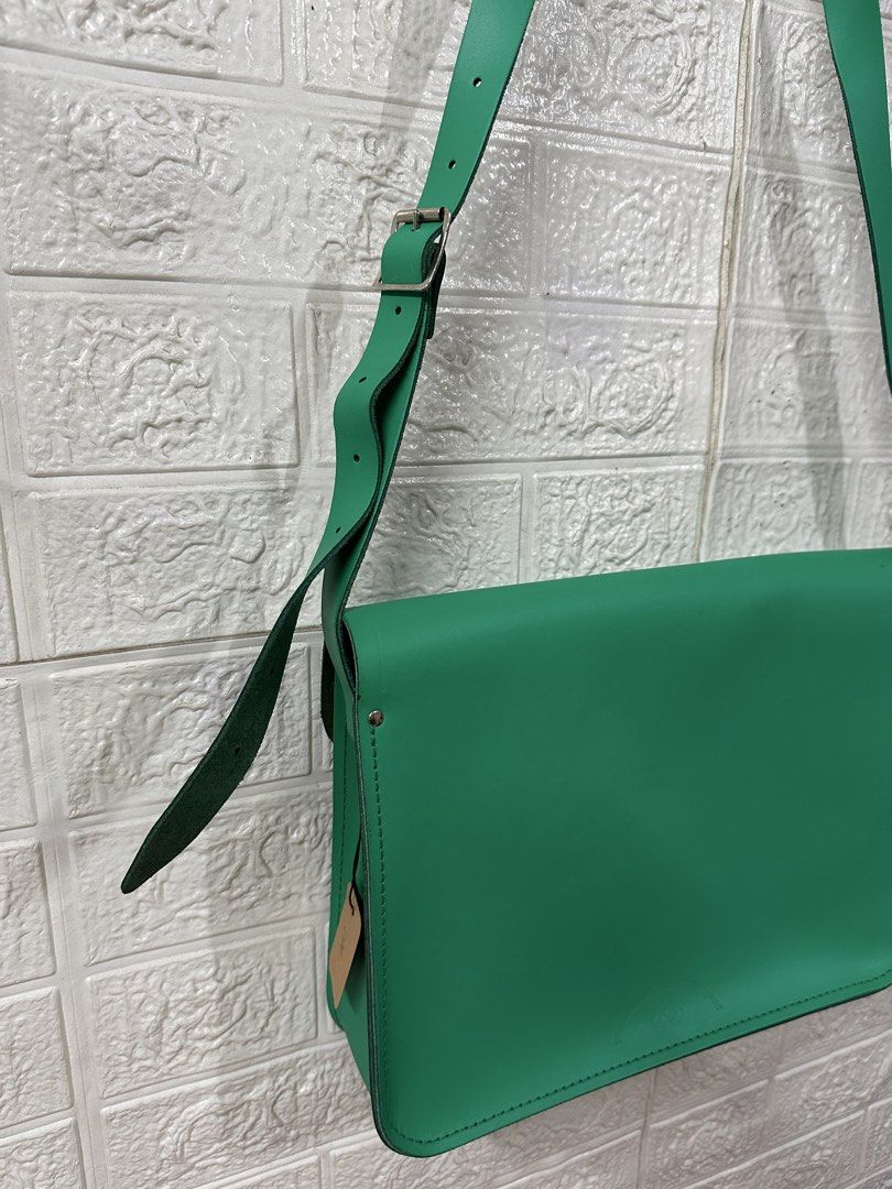 The Cambridge Satchel Company Green Leather Satchel Bag (Category: Luxury Bags & Wallets) located in Bacoor. Submitted by reneejhay (Listing ID 1444983361, Image 3). Description: - Genuine green leather satchel bag - Brand: The Cambridge Satchel Company - Classic design with secure buckle closures - Adjustable shoulder strap for comfort - Ample interior space for essentials - Perfect for everyday use or as a stylish statement piece - A timeless a