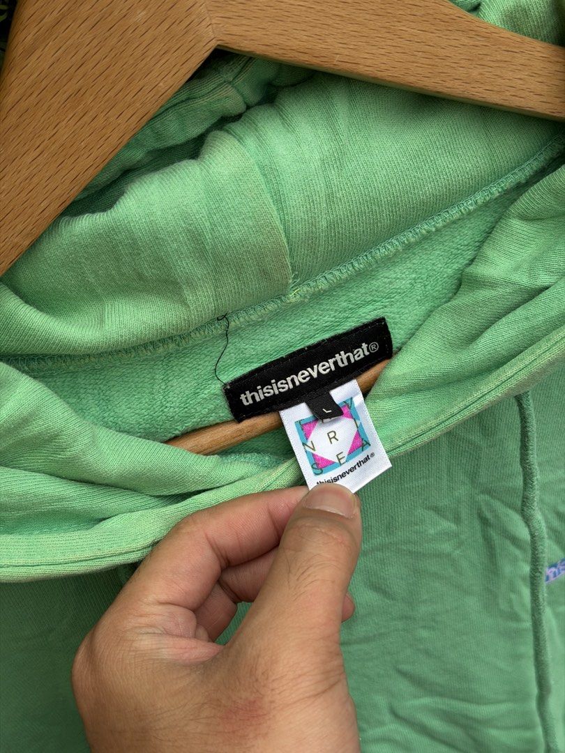 thisisneverthat Green Hoodie with Sleeve Logo (Category: Hoodies) located in Bacolod City. Submitted by Ms_OnlineBoutiqe (Listing ID 1444945652, Image 3). Description: - Authentic thisisneverthat green hoodie -width 24 -length 27 - Bold blue brand name printed on chest - Repeating blue logo down both sleeves - Comfortable pullover style - Convenient front pocket.