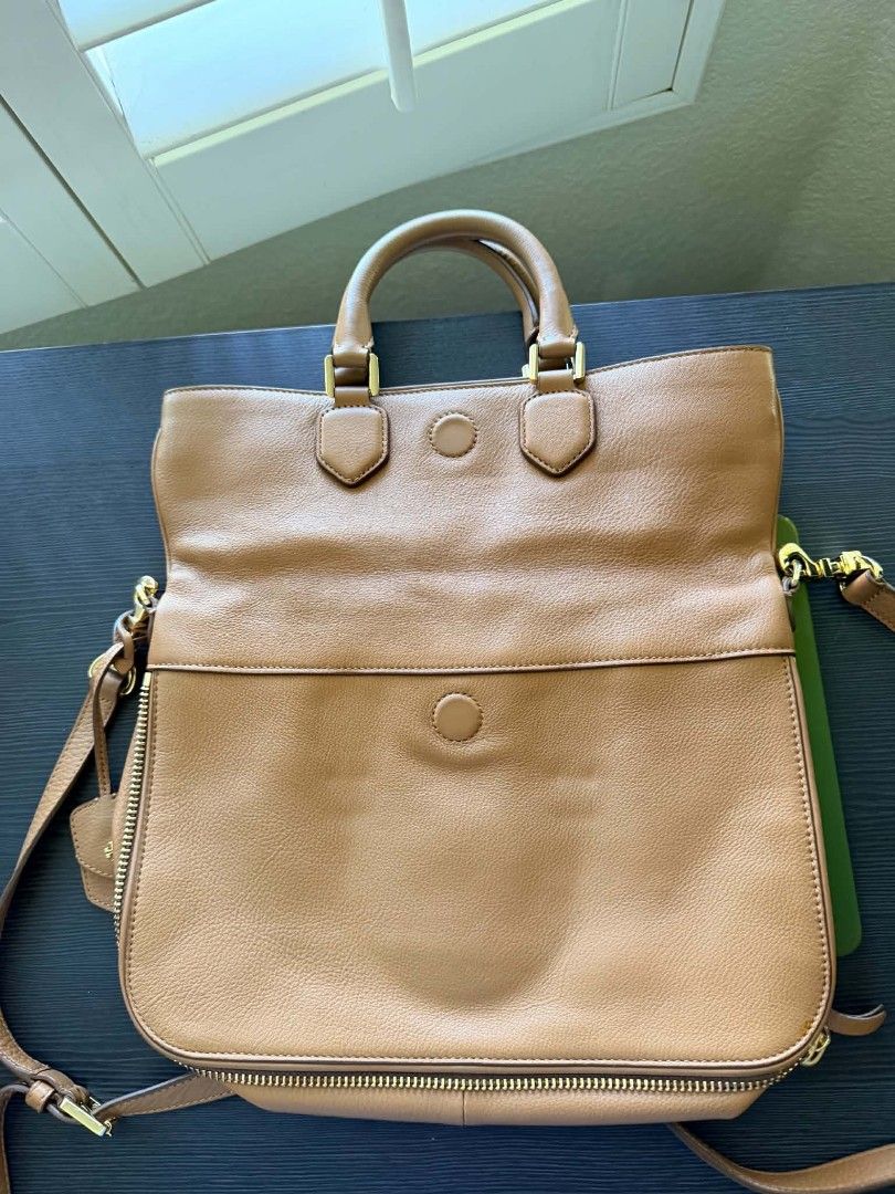 Tory Burch Leather Tote Bag (Category: Luxury Bags & Wallets) located in Quezon City. Submitted by plus4lessshop (Listing ID 1445042353, Image 3). Description: - Authentic Tory Burch brown leather tote bag - Versatile carrying options: top handles and detachable crossbody strap - Expandable design with side zippers - Elegant gold hardware details - Ample interior space for all your essentials - Ideal for everyday use and stylish on-the-go.