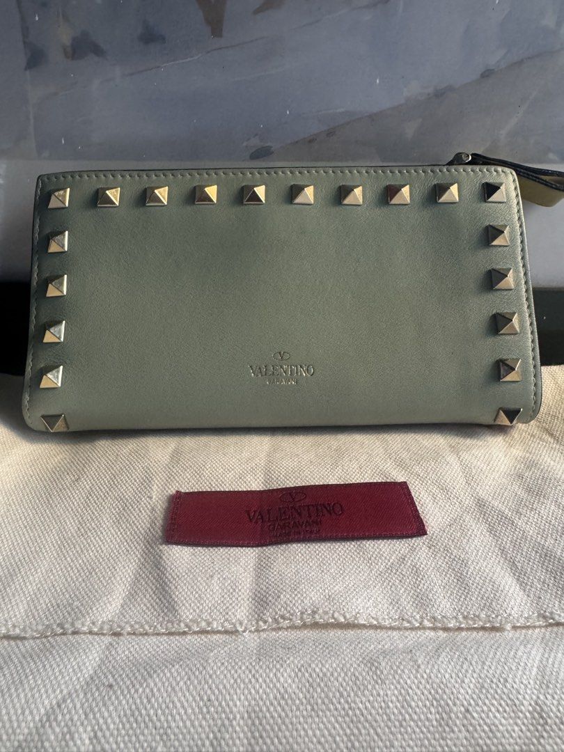 Valentino Garavani Rockstud Leather Wallet (Category: Luxury Bags & Wallets) located in Paranaque City. Submitted by msjam63 (Listing ID 1444949985, Image 1). Description: - Authentic Valentino Garavani wallet -Made in Italy -Pastel Tri-color blue, pink and green Rare - Signature Rockstud detailing - Top zip coin slot -Multiple card slot - Multiple interior card slots and compartments - Comes with dust bag - Ideal for organizing your essentials -