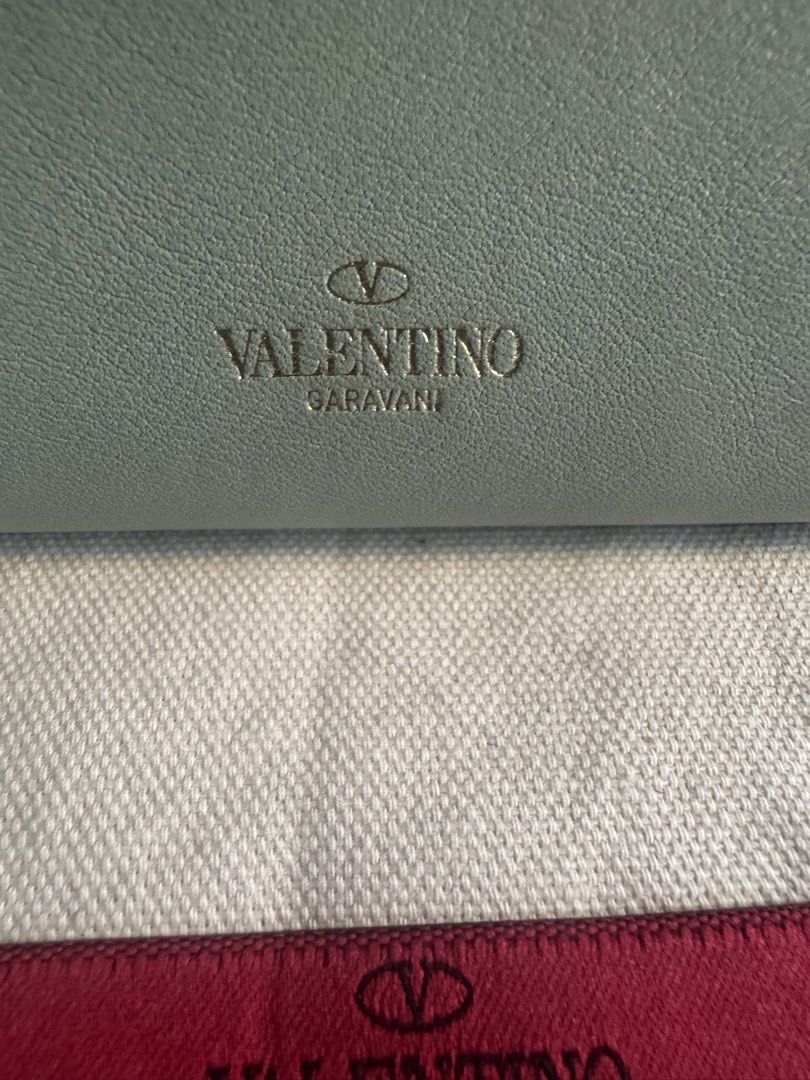 Valentino Garavani Rockstud Leather Wallet (Category: Luxury Bags & Wallets) located in Paranaque City. Submitted by msjam63 (Listing ID 1444949985, Image 2). Description: - Authentic Valentino Garavani wallet -Made in Italy -Pastel Tri-color blue, pink and green Rare - Signature Rockstud detailing - Top zip coin slot -Multiple card slot - Multiple interior card slots and compartments - Comes with dust bag - Ideal for organizing your essentials -