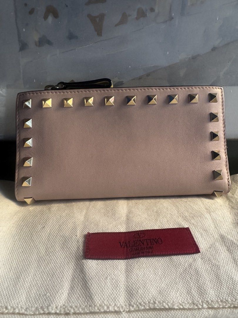 Valentino Garavani Rockstud Leather Wallet (Category: Luxury Bags & Wallets) located in Paranaque City. Submitted by msjam63 (Listing ID 1444949985, Image 3). Description: - Authentic Valentino Garavani wallet -Made in Italy -Pastel Tri-color blue, pink and green Rare - Signature Rockstud detailing - Top zip coin slot -Multiple card slot - Multiple interior card slots and compartments - Comes with dust bag - Ideal for organizing your essentials -