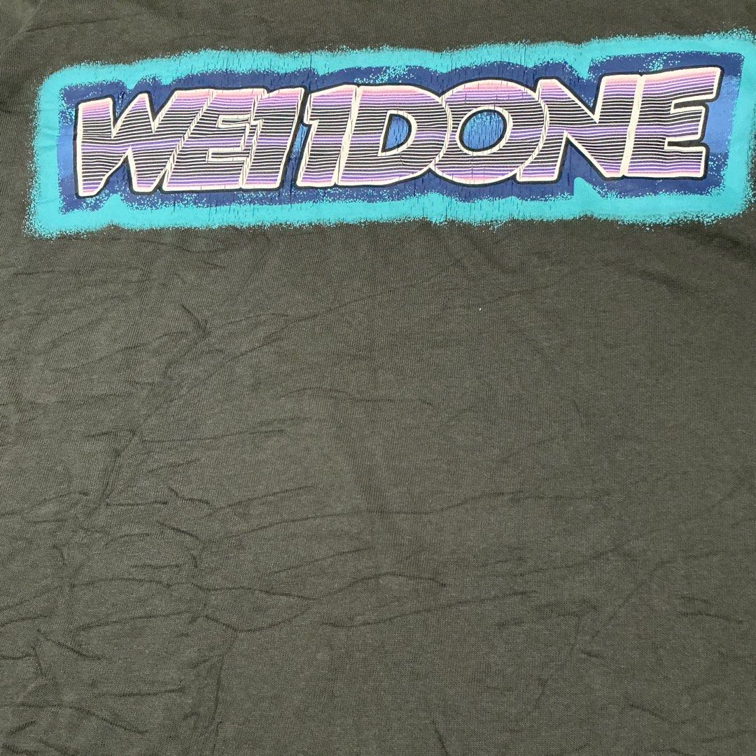 WE11DONE Oversized Graphic T-Shirt (Category: Tshirts & Polo Shirts ) located in Naga. Submitted by eunhasowon12391 (Listing ID 1444900019, Image 3). Description: - Grey WE11DONE oversized t-shirt - Size: L - Material: 100% Cotton - Features: Bold graphic print on back, small embroidered logo on front chest - Style: Relaxed, streetwear - Condition: Please check photos for details.