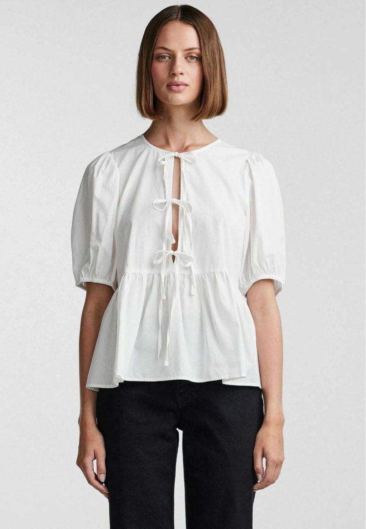 White Tie Front Peplum Blouse Puff Sleeve (Category: Blouses) located in Roxas City. Submitted by plumpop_ (Listing ID 1444920601, Image 2). Description: - White peplum blouse - Puff sleeves with elastic cuffs - Adjustable tie-front detail at neckline and waist - Multiple ties for customizable fit - Can be styled casually or dressed up.