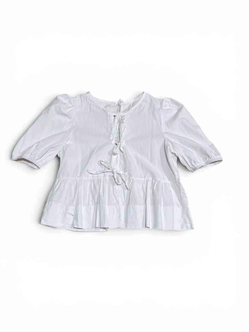 White Tie Front Peplum Blouse Puff Sleeve (Category: Blouses) located in Roxas City. Submitted by plumpop_ (Listing ID 1444920601, Image 1). Description: - White peplum blouse - Puff sleeves with elastic cuffs - Adjustable tie-front detail at neckline and waist - Multiple ties for customizable fit - Can be styled casually or dressed up.