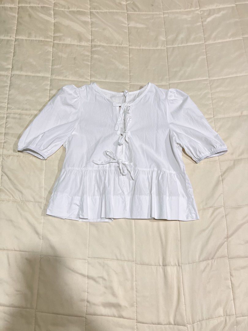 White Tie Front Peplum Blouse Puff Sleeve (Category: Blouses) located in Roxas City. Submitted by plumpop_ (Listing ID 1444920601, Image 3). Description: - White peplum blouse - Puff sleeves with elastic cuffs - Adjustable tie-front detail at neckline and waist - Multiple ties for customizable fit - Can be styled casually or dressed up.