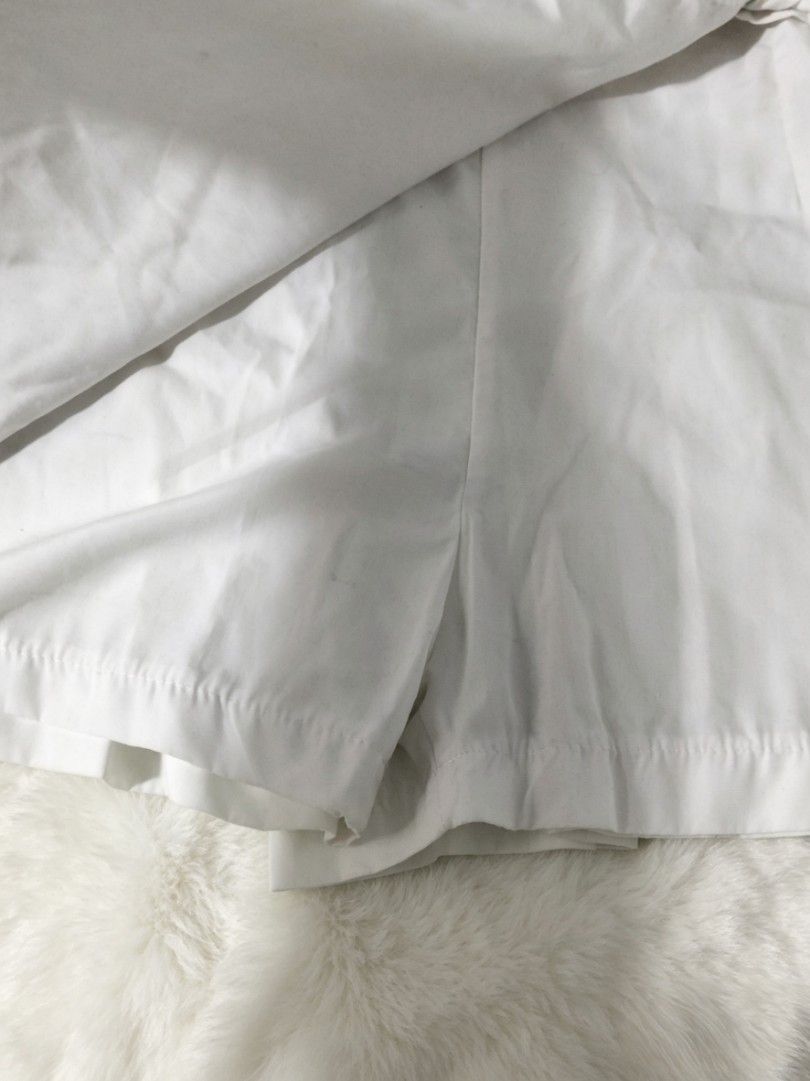 White Wrap Skirt with Tie Detail (Category: Skirts) located in Quezon City. Submitted by mayyang_28 (Listing ID 1444967347, Image 2). Description: - White wrap skirt - Mini skirt style - Adjustable tie closure on the side - Made of plain white cotton fabric - Versatile for casual wear or as a beach cover-up.
