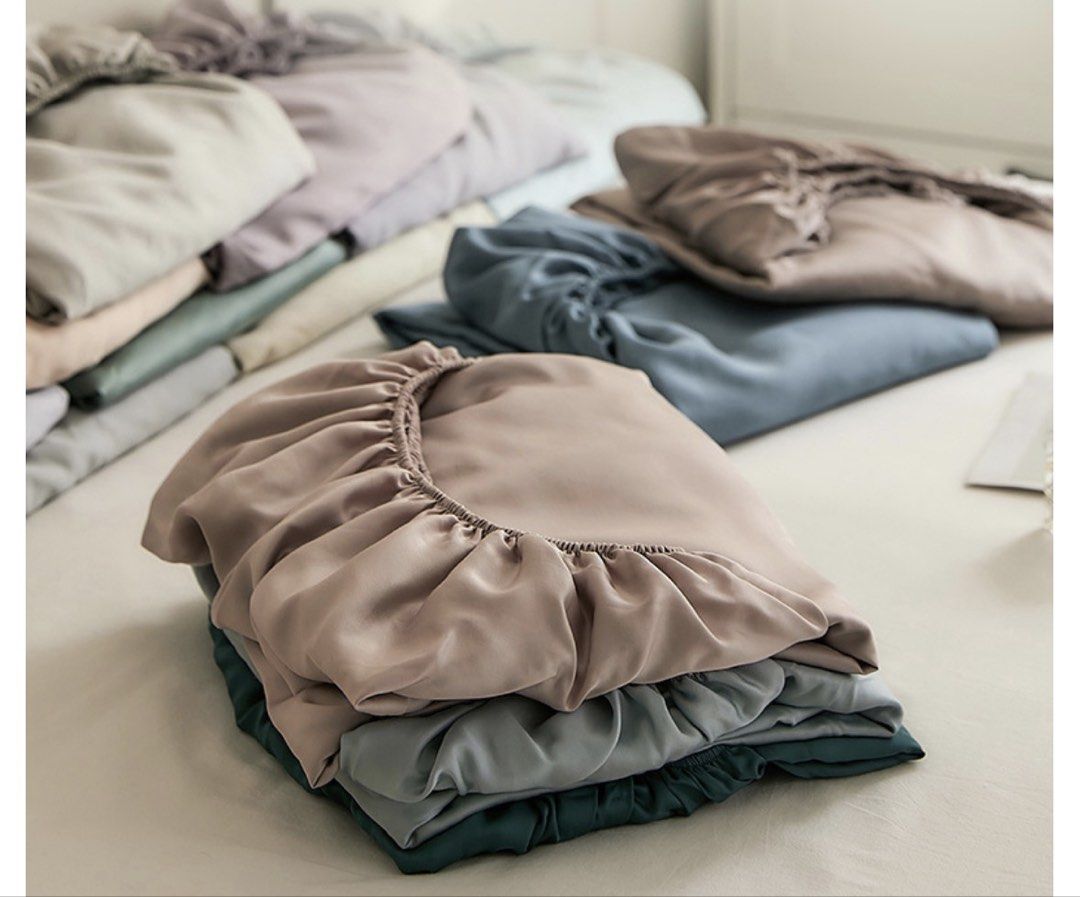 1.5M Tencel Fitted Bed Sheets with Elastic Edges and Pillowcases - Multiple Colors (Category: Bedding & Towels) located in Singapore. Submitted by swifthorse.ace74d (Listing ID 1445169885, Image 2). Description: - Fitted bed sheets with elastic for easy fitting. - Available in muted colors: dusty rose, dusty blue, dark grey. - Made from a smooth, soft fabric. - Enhances bedroom comfort and style. One fitted sheet S$35. Two pillowcases S$20. One f
