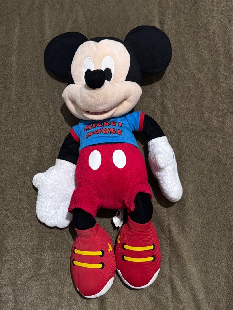 23 inch Authentic Disney Mickey Mouse Plush Toy 2015 (Category: Plushies & Soft Toys) located in Taguig. Submitted by misstangerine (Listing ID 1445163445, Image 1). Description: - Classic Mickey Mouse plush toy - Iconic outfit: red shorts, blue shirt ('Mickey Mouse' print), red shoes - Shoe detail: '2015' printed on the back - Ideal for Disney fans and collectors - Soft and huggable material - bought in Disney California.