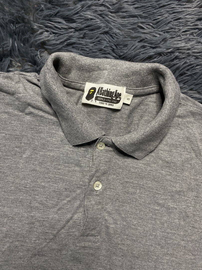 A Bathing Ape BAPE Shark Polo Shirt Grey (Category: Tshirts & Polo Shirts ) located in Manila. Submitted by mysticstar_4e4227 (Listing ID 1445201077, Image 2). Description: - Grey BAPE polo shirt - Features iconic shark graphic - Short sleeves - Collared neckline with button closure - Made in Bangladesh - Tag details visible in photos - Ideal addition to any streetwear collection .