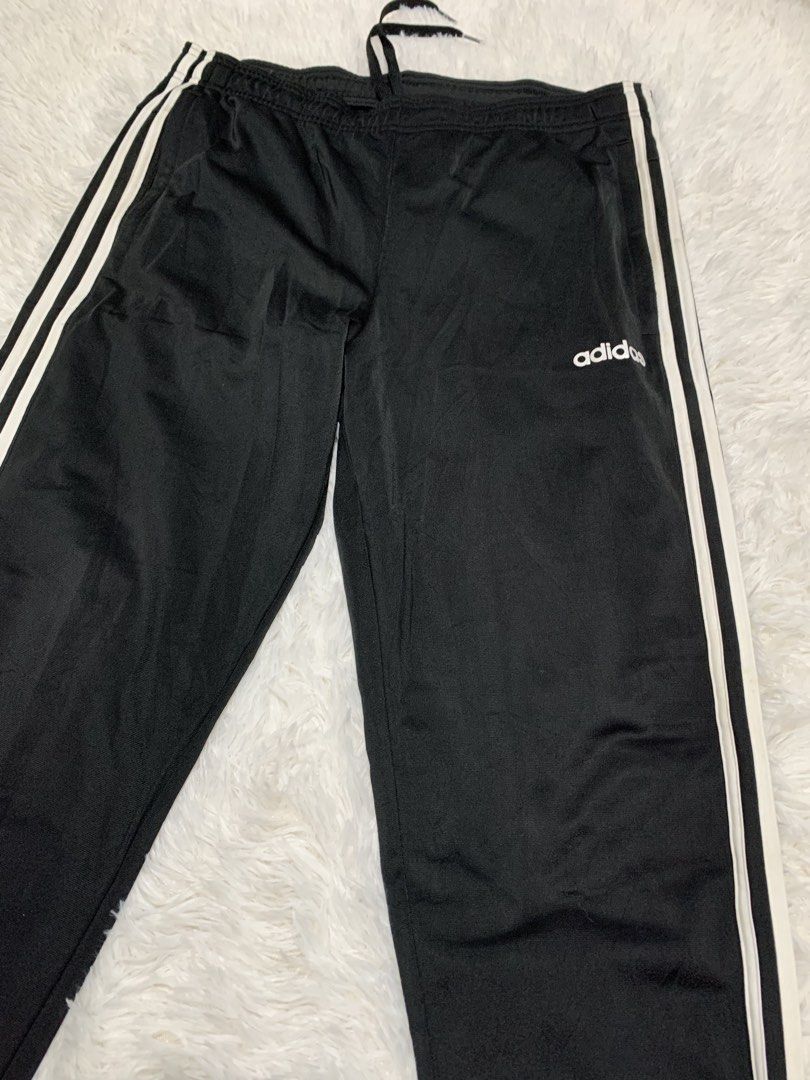 Adidas Black Track Pants with White Stripes (Category: Joggers) located in Iba. Submitted by thriftcoyan (Listing ID 1445185975, Image 3). Description: - Classic Adidas track pants -Size 32-34 -issue dumi lang sa white part - Color: Black with iconic white side stripes - Features: Elastic waistband with drawstring for adjustable comfort - Design: Cuffed ankles - Versatile: Ideal for sports, workouts, or everyday casual wear - Easy to style with a