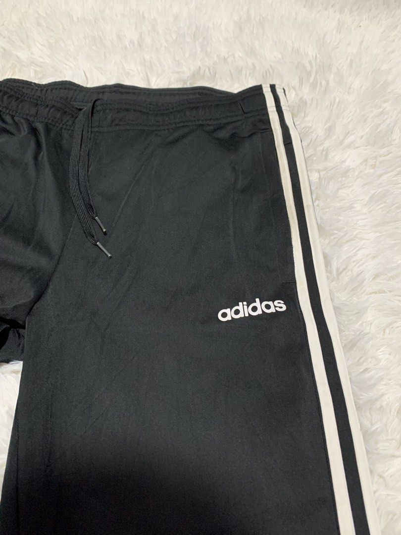 Adidas Black Track Pants with White Stripes (Category: Joggers) located in Iba. Submitted by thriftcoyan (Listing ID 1445185975, Image 2). Description: - Classic Adidas track pants -Size 32-34 -issue dumi lang sa white part - Color: Black with iconic white side stripes - Features: Elastic waistband with drawstring for adjustable comfort - Design: Cuffed ankles - Versatile: Ideal for sports, workouts, or everyday casual wear - Easy to style with a
