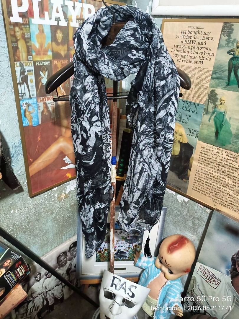 Angel and Demons Scarf random brand (Category: Scarves) located in Santo Tomas. Submitted by pickers_corner (Listing ID 1445201870, Image 1). Description: - Lightweight scarf with a detailed black and white graphic print. - Features a repeating pattern of skeletal figures and angelic beings. - Measures approximately [insert length] by [insert width]. - Can be styled in many ways. - Adds a unique touch to any outfit..