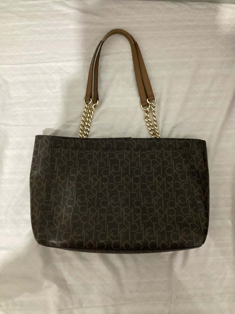 Authentic Calvin Klein Bag (Category: Luxury Bags & Wallets) located in Batangas. Submitted by snpfinds. (Listing ID 1445064344, Image 3). Description: - Authentic Brown Calvin Klein Shoulder Bag - LAST PRICE!!!!!! - All-over CK Monogram Print - Gold Chain and Leather Shoulder Straps - Classic Tote Shape - Ideal for Everyday Use - Spacious Interior for All Your Essentials - Clean and Timeless Design.