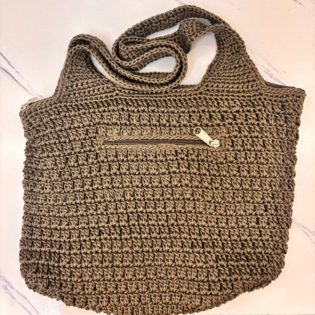 Bali Crocheted Shoulder Bag with Zipper Pocket (Category: Shoulder Bags) located in Cainta. Submitted by angeli.6229 (Listing ID 1445110241, Image 1). Description: - Bought from Bali, Indonesia - Lined khaki green crocheted shoulder bag - Front zippered pocket for essentials - Adjustable crocheted strap for comfort - Spacious interior, ideal for everyday carry - Unique texture and design.