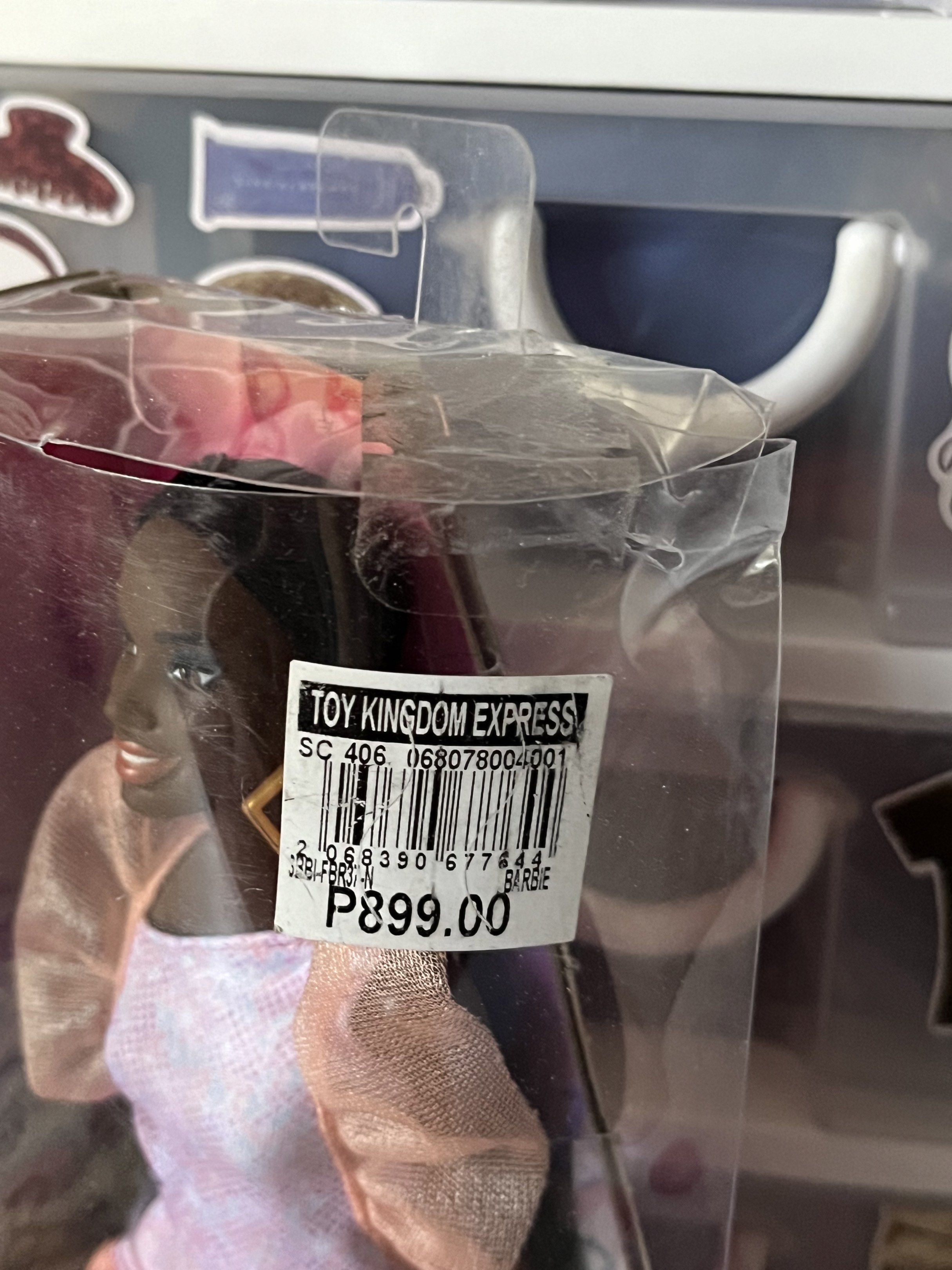 Black Barbie Doll brand new (Category: Kids Toys) located in Makati City. Submitted by starboy17 (Listing ID 1445054490, Image 2). Description: - Brand new Barbie doll in original, unopened packaging. - Features a beautiful dark-skinned doll. - Doll is wearing a stylish pink and white patterned dress with sheer puff sleeves. - Accessorized with gold hoop earrings. - Comes in a clear plastic box with original Toy Kingdom Express price tag (P899.00