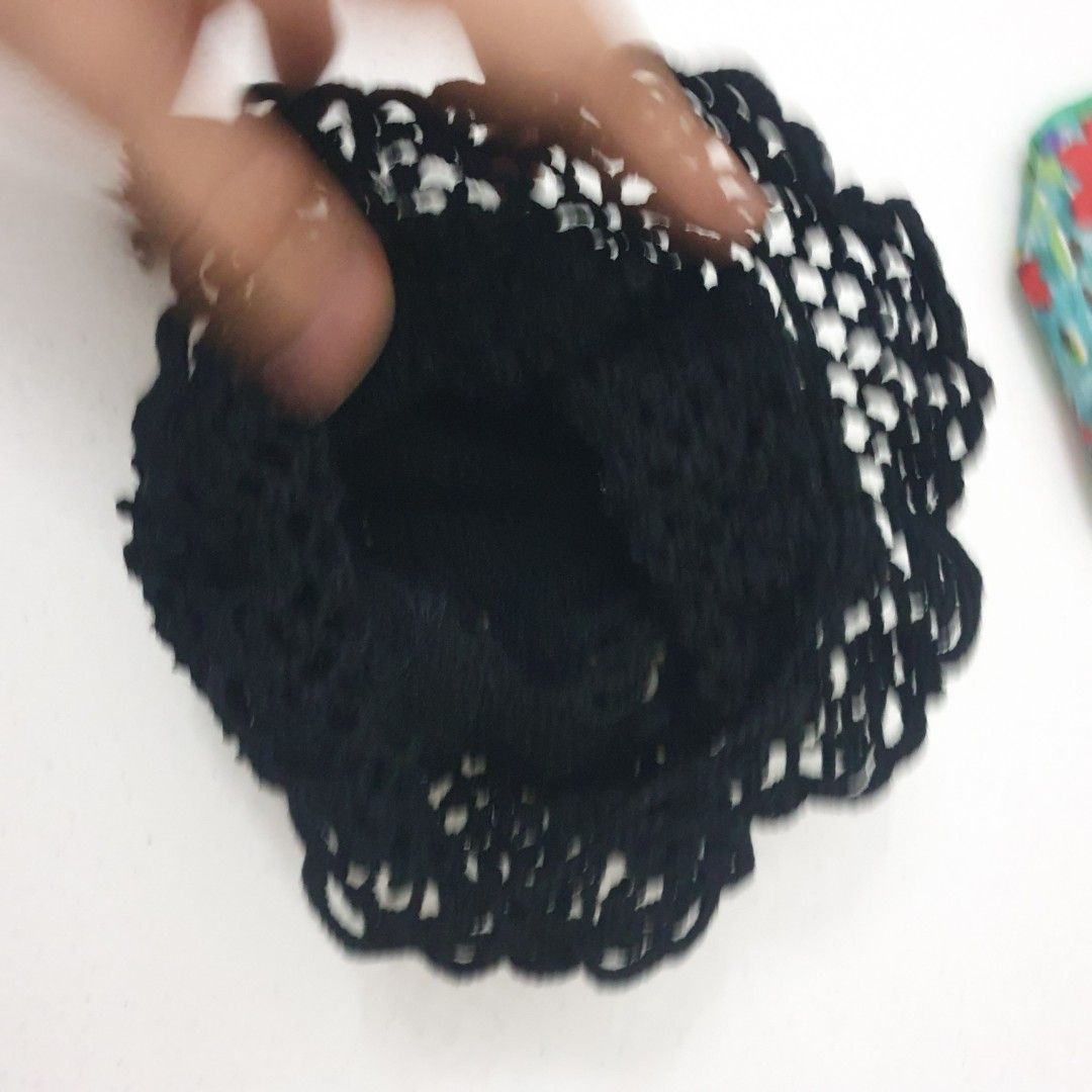 Black Crochet Drawstring Pouch and Floral Makeup Bag (Category: Purses & Pouches) located in Paranaque City. Submitted by cobien (Listing ID 1445224035, Image 3). Description: - Black crochet drawstring pouch with elegant pearl accents and tassels. - Pouch measures approximately 8 inches in diameter when laid flat. - Includes a separate floral print makeup pouch with a built-in mirror. - Floral makeup pouch features a green trim and secure zipper