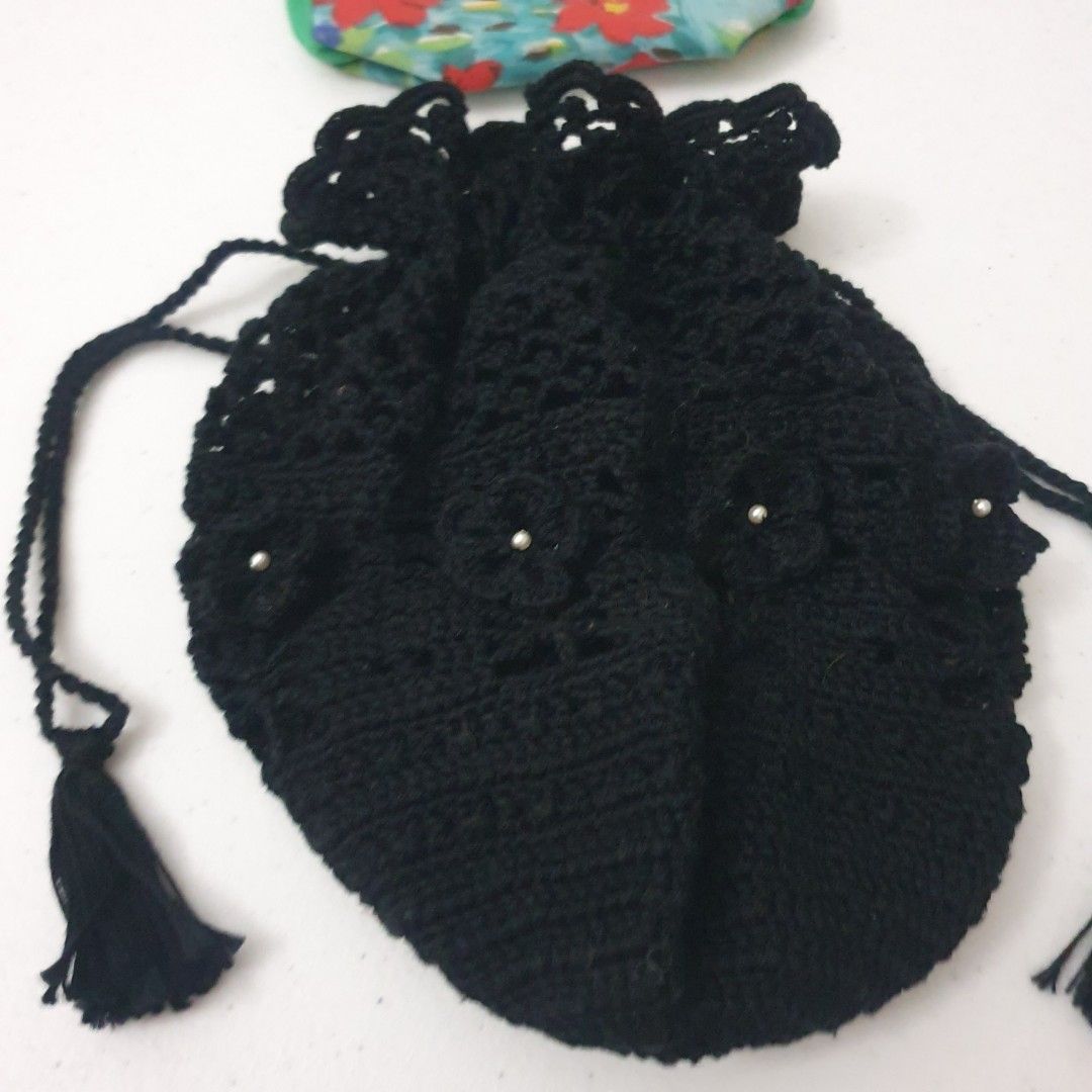 Black Crochet Drawstring Pouch and Floral Makeup Bag (Category: Purses & Pouches) located in Paranaque City. Submitted by cobien (Listing ID 1445224035, Image 2). Description: - Black crochet drawstring pouch with elegant pearl accents and tassels. - Pouch measures approximately 8 inches in diameter when laid flat. - Includes a separate floral print makeup pouch with a built-in mirror. - Floral makeup pouch features a green trim and secure zipper