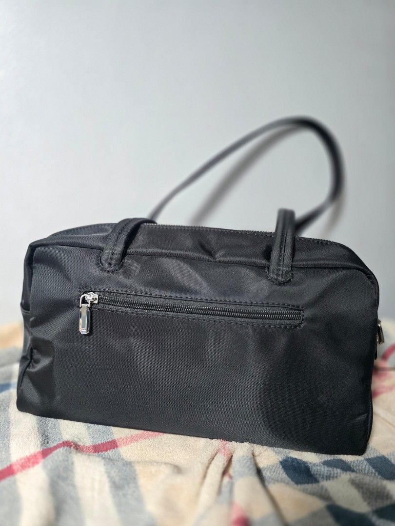 Black Nylon Shoulder Bag with Coin Pouch (Category: Luxury Bags & Wallets) located in Manila. Submitted by chubbychic553 (Listing ID 1445234221, Image 2). Description: PRELOVED BRAND: ALBERTO Inclusion a small, attached coin pouch & ecobag zip closure for the main compartment used 2x kaya bagong bago pa flaw: Minor reddish mark on the exterior near the zipper (washable) Php 1200 location Tayuman Manila shipping via lbc or lalamove NO COD NO COP p