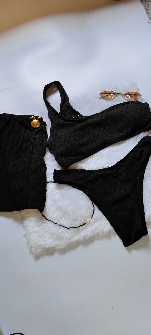 Black Ribbed One-Shoulder Bikini Set with Skirt (Category: Bikinis & Swimsuits) located in Caloocan City. Submitted by catherinef09905 (Listing ID 1445139551, Image 1). Description: - Black ribbed bikini set - One-shoulder top - High-waisted bottoms - Matching ribbed skirt with gold button detail - Subtle textured fabric pattern - Size M on tag - Ideal for beach or pool days.