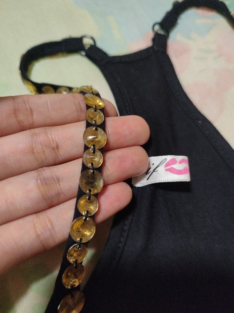 Black Mini Dress with Embellished Straps (Category: Dresses) located in Jaen. Submitted by roxantiago (Listing ID 1445101395, Image 3). Description: - Classic black tank top - Flattering racerback design - Unique gold-toned circular embellishments on straps - Soft and stretchy fabric for comfort - Versatile for layering or standalone wear S to M.