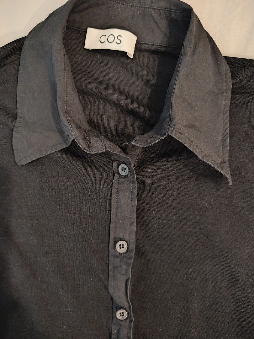 COS Black Long Sleeve Button Up Shirt (Category: Longsleeves) located in Makati City. Submitted by shopsaleph (Listing ID 1445053541, Image 1). Description: - COS black long sleeve shirt - Button-up front with classic collar - Button detail on cuffs - Soft and stretchy material - Ideal for layering or wearing on its own - Versatile wardrobe staple.