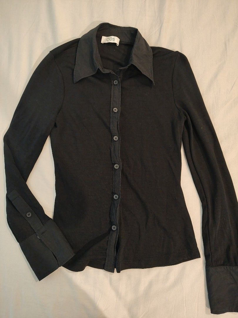 COS Black Long Sleeve Button Up Shirt (Category: Longsleeves) located in Makati City. Submitted by shopsaleph (Listing ID 1445053541, Image 2). Description: - COS black long sleeve shirt - Button-up front with classic collar - Button detail on cuffs - Soft and stretchy material - Ideal for layering or wearing on its own - Versatile wardrobe staple.