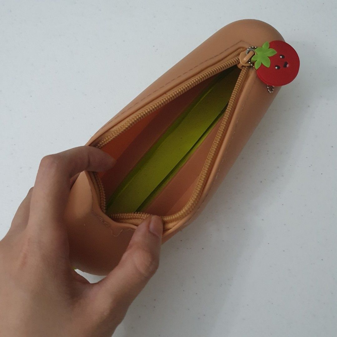 Cute Hot Dog Pencil Case silicone Pouch (Category: Stationery & School Supplies) located in Paranaque City. Submitted by cobien (Listing ID 1445223842, Image 2). Description: - Fun hot dog shaped pencil case - Ideal for stationery or makeup storage - Adorable design with a cute face - Features a unique tomato zipper pull - Approximately 8.5 inches in length - Playful and eye-catching design.