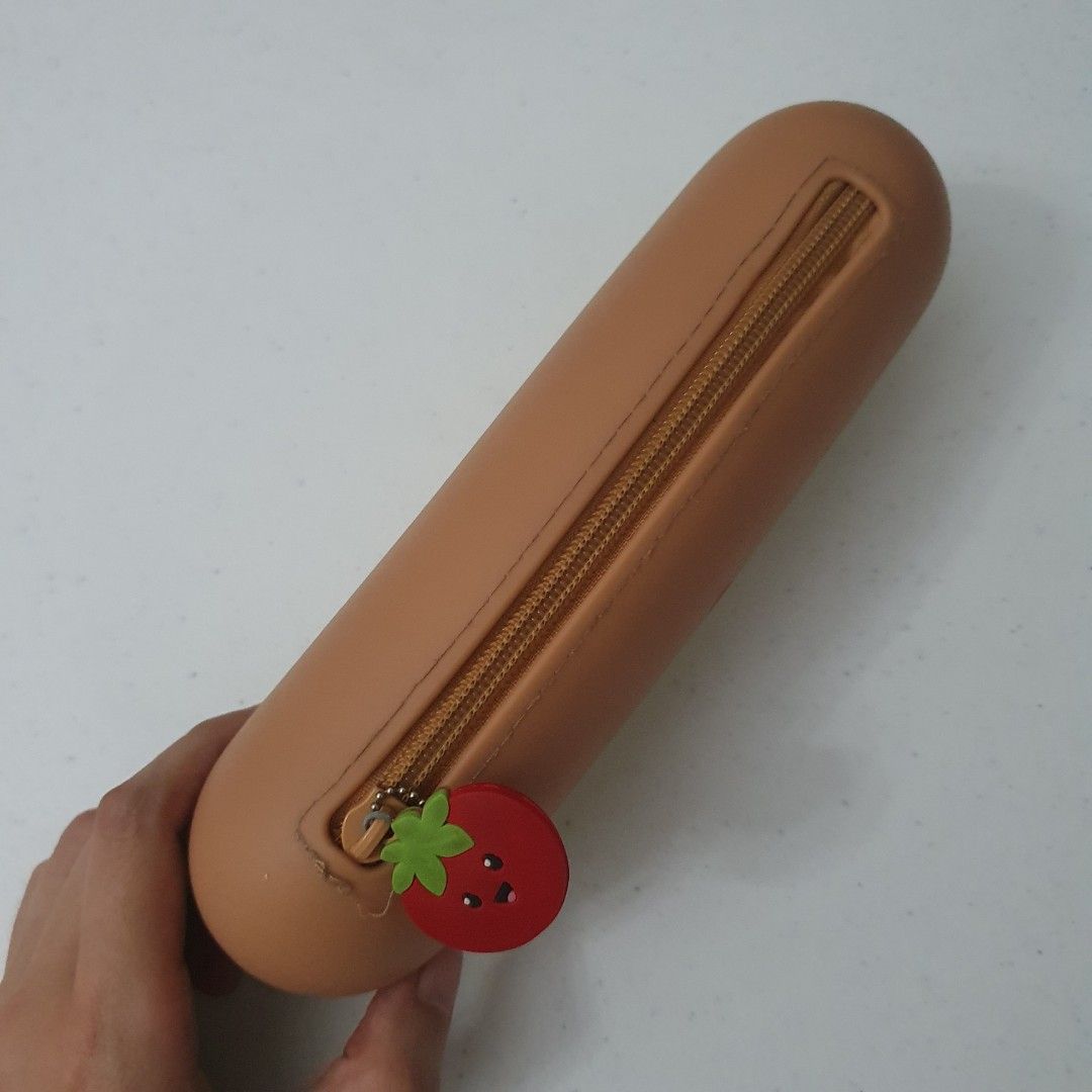 Cute Hot Dog Pencil Case silicone Pouch (Category: Stationery & School Supplies) located in Paranaque City. Submitted by cobien (Listing ID 1445223842, Image 3). Description: - Fun hot dog shaped pencil case - Ideal for stationery or makeup storage - Adorable design with a cute face - Features a unique tomato zipper pull - Approximately 8.5 inches in length - Playful and eye-catching design.