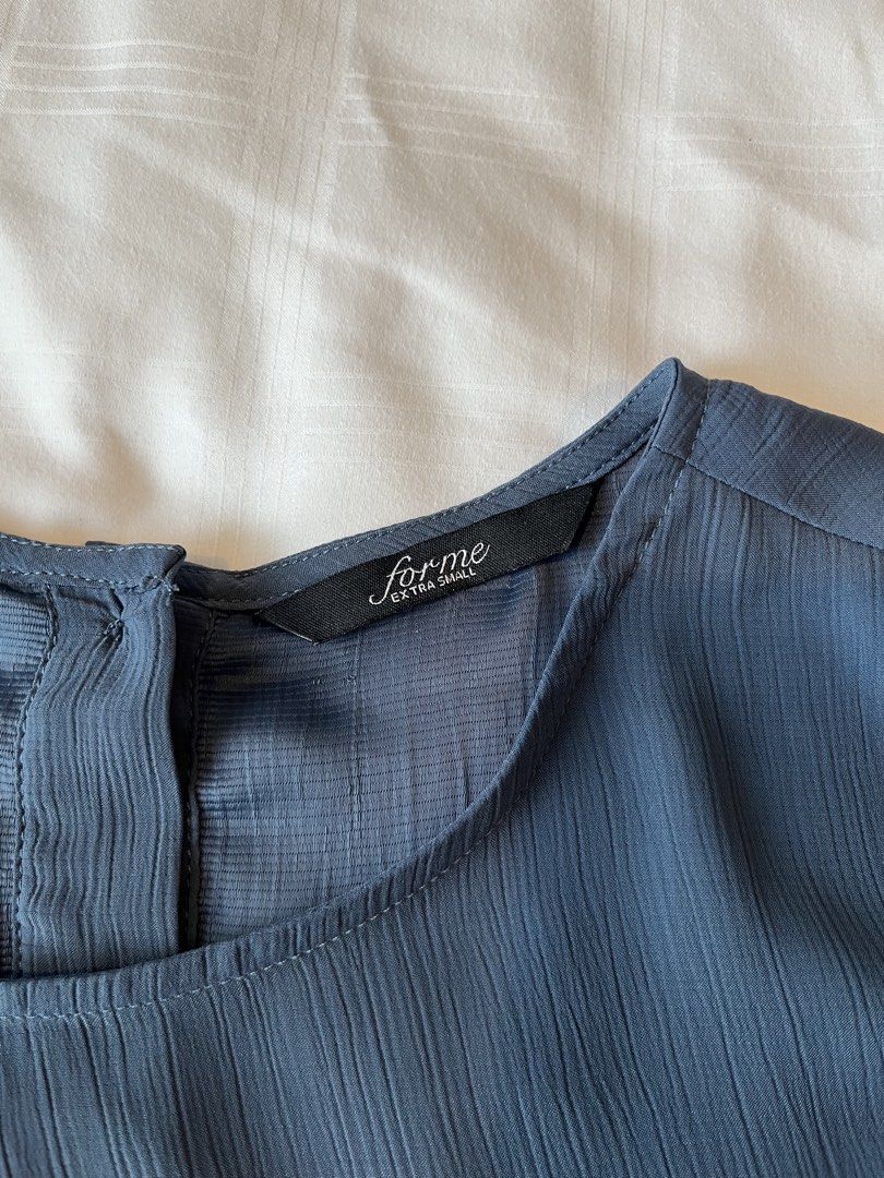 For Me Extra Small Blue Textured Short Sleeve Top (Category: Blouses) located in Quezon City. Submitted by aimeeob (Listing ID 1445157254, Image 2). Description: ForMe blue top. Textured fabric, short sleeves, button back closure. Versatile for casual wear..