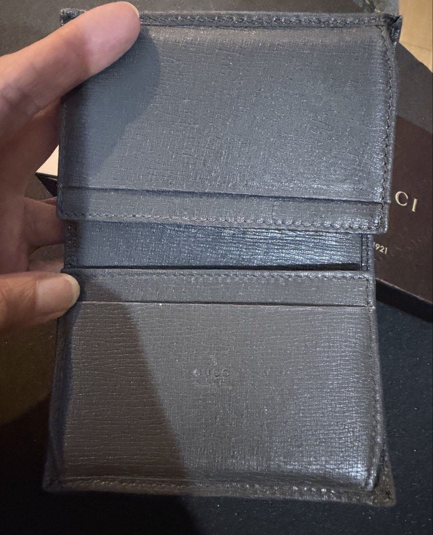Gucci Grey Leather Bi-fold Wallet with Box (Category: Luxury Bags & Wallets) located in San Fernando. Submitted by mhedkm (Listing ID 1445086361, Image 2). Description: - Authentic Gucci Wallet - Color: Grey - Material: Leather - Design: Bi-fold - Includes: Original Gucci Box and Authenticity Cards - Features: Ample card slots and a coin pouch .