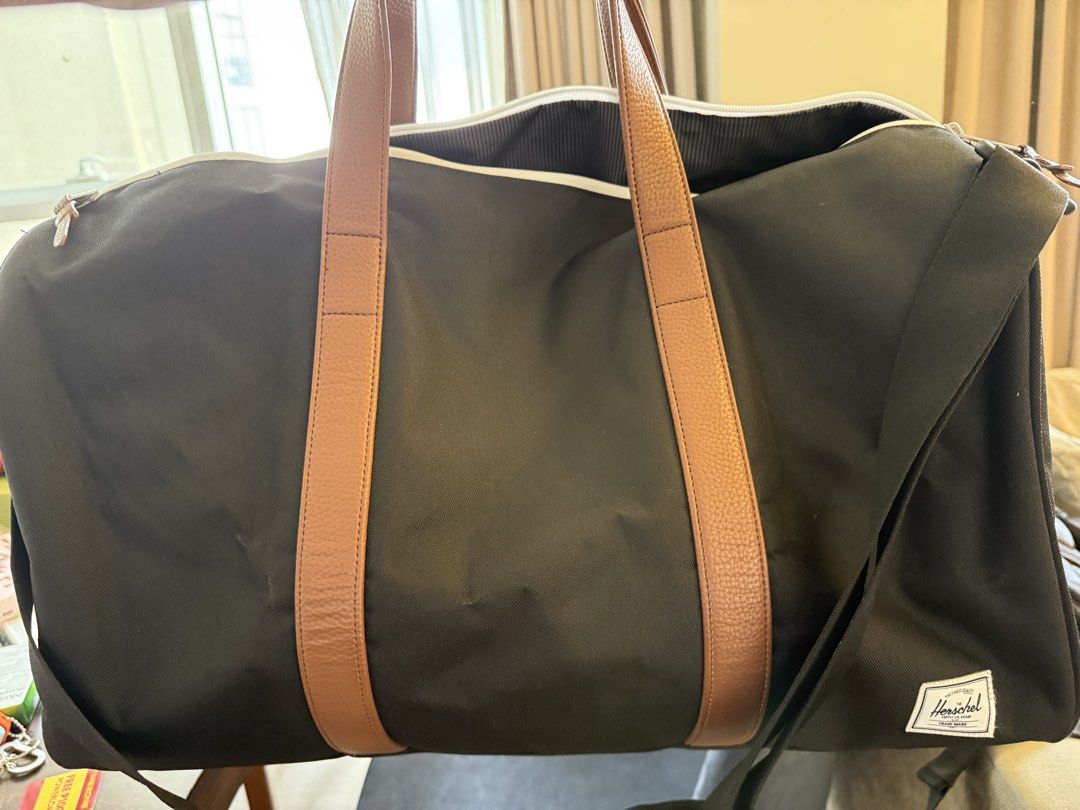 Herschel Black Duffel Bag with Tan Straps (Category: Cross-body Bags) located in Manila. Submitted by opiumbycece (Listing ID 1445113090, Image 1). Description: Used once Authentic Bought for almost 7k RFS: major decluttering .