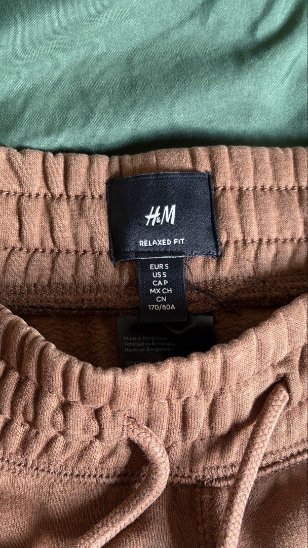 H&M Relaxed Fit Sweatpants - Size S (Category: Joggers) located in Caloocan City. Submitted by _preloved_bb (Listing ID 1445103266, Image 3). Description: - Brand: H&M - Color: Brownish-pink - Fit: Relaxed - Style: Jogger sweatpants - Size: S - Features: Elastic waistband with drawstring, two side pockets, cuffed ankles - Material: Made in Bangladesh - Measurements: Length approx. 39 inches, Waist approx. 13 inches (unstretched).