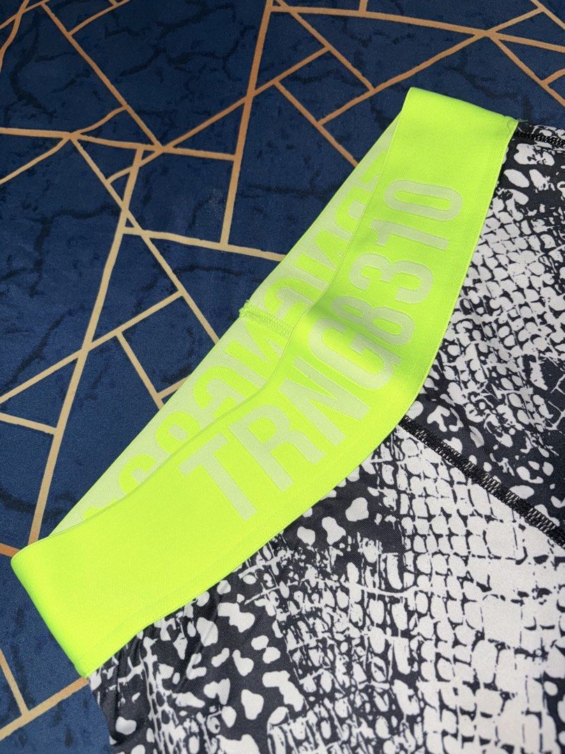 H&M Sport Leggings M (Category: Other Bottoms) located in Paranaque City. Submitted by cosmicwolf_f03751 (Listing ID 1445154922, Image 2). Description: H&M Sport Patterned Leggings with Zipper Pocket Brand: Original H&M Sport Size: EUR M / US M (Fits Medium) Features: Eye-catching snakeskin/animal print texture, vibrant neon green “TRNG 8310” elastic waistband. Super convenient back zippered pocket for keys/cash while working out. Perfect for gym