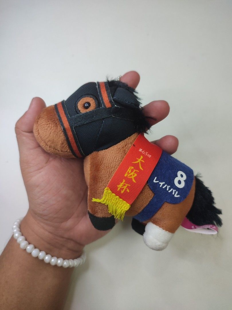 Horse Plush Toy Keychain - Thoroughbred Collection (Category: Plushies & Soft Toys) located in Manila. Submitted by epicmountain-f20453 (Listing ID 1445101653, Image 2). Description: - Adorable horse plush toy keychain. - Part of the exclusive Thoroughbred Collection. - Dressed in a jockey outfit with the number '8'. - Includes unique Japanese text detail. - Ideal gift for horse racing enthusiasts or a charming accessory..