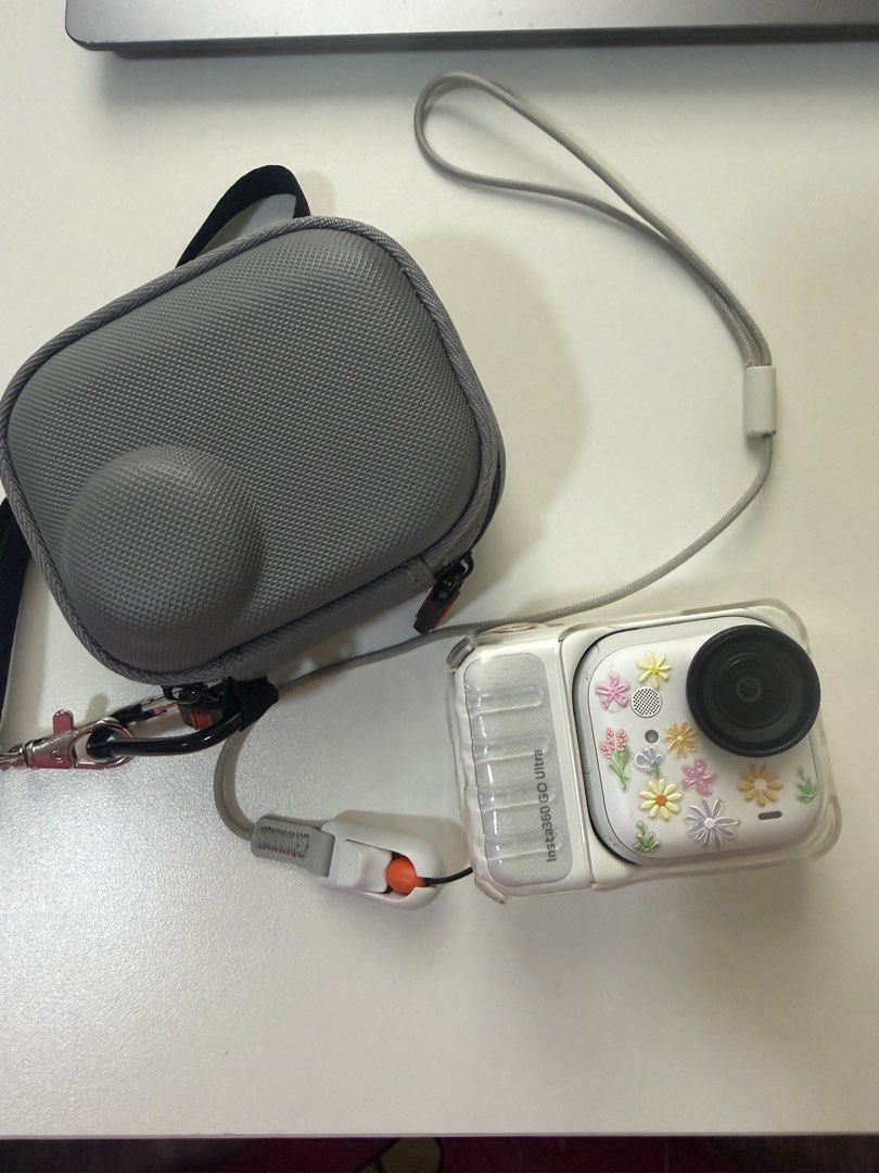 Insta360 GO Ultra Tiny Hands-Free 4K Cam (Category: Cameras) located in Pasig City. Submitted by danda24 (Listing ID 1445049011, Image 3). Description: - Insta360 GO Ultra: Tiny, hands-free 4K action camera. - Condition: Used, with a cute floral sticker design. - Inclusions: Original box, charging cable, protective case, lanyard, and a small black mount. - Key Feature: Effortlessly capture moments on the go without holding the camera. rfs: upgrad