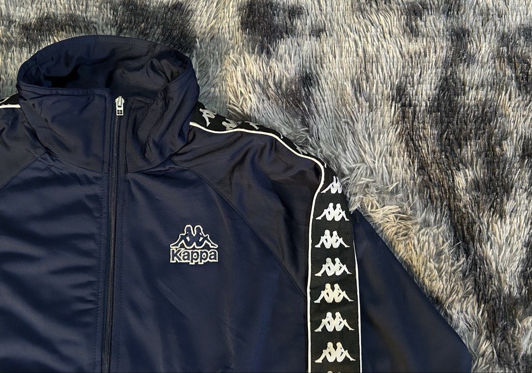Kappa Track Jacket Navy Blue W23 L27 (Category: Coats, Jackets and Outerwear) located in Cadiz. Submitted by jaybatiller (Listing ID 1445048910, Image 3). Description: - Classic Kappa track jacket - Navy blue with white taping on sleeves - Full zip closure - Ribbed cuffs and hem - Ideal for casual wear or sports - Size: Medium.