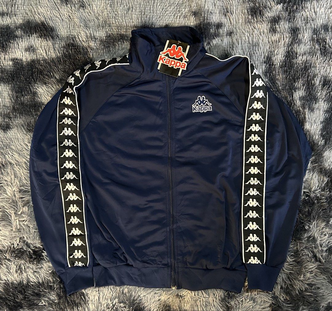 Kappa Track Jacket Navy Blue W23 L27 (Category: Coats, Jackets and Outerwear) located in Cadiz. Submitted by jaybatiller (Listing ID 1445049052, Image 2). Description: - Classic Kappa track jacket - Navy blue with white taping on sleeves - Iconic Kappa logo on chest and sleeve - Zip-up front with stand-up collar - Ideal for casual wear or sports.