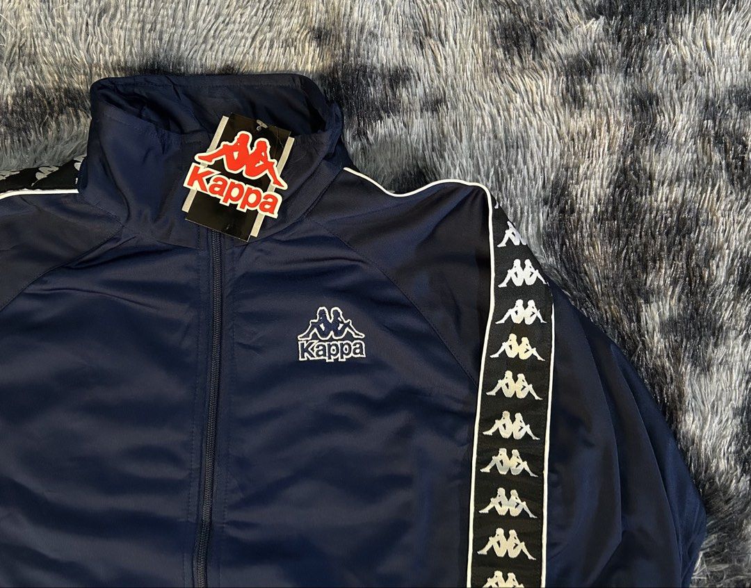 Kappa Track Jacket Navy Blue W23 L27 (Category: Coats, Jackets and Outerwear) located in Cadiz. Submitted by jaybatiller (Listing ID 1445049052, Image 3). Description: - Classic Kappa track jacket - Navy blue with white taping on sleeves - Iconic Kappa logo on chest and sleeve - Zip-up front with stand-up collar - Ideal for casual wear or sports.
